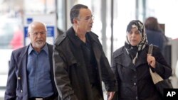 FILE - Family members of Abdella Ahmad Tounisi, including his father Ahmad Tounisi, center, leave the Dirksen Federal Building in Chicago, April 23, 2013.