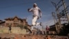 Kashmiris run for cover as Indian security forces (not pictured) fire tear gas shells during clashes, after scrapping of the special constitutional status for Kashmir by the Indian government, in Srinagar.