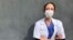 FILE - Aurelie Gouel, an ICU doctor who has recovered from COVID-19, poses during a break in her shift treating coronavirus patients at Bichat Hospital in Paris, April 7, 2020.
