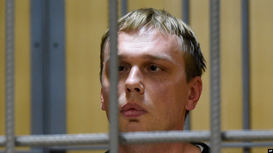 Ivan Golunov, a journalist who worked for the independent website Meduza, sits in a cage in a court room in Moscow, June 8, 2019. 