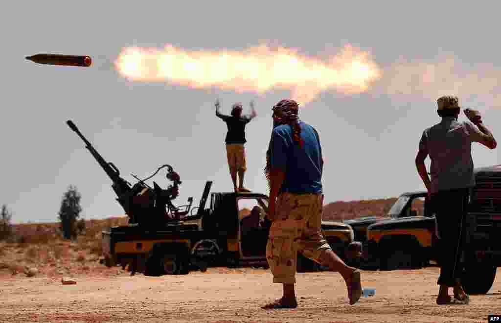 Anti-Gadhafi fighters fire a multiple rocket launcher near Sirte, one of his last remaining strongholds, September 24, 2011. (Reuters)