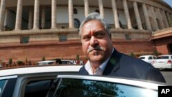 FILE - Indian business tycoon Vijay Mallya gets into his car outside the Parliament in New Delhi, India, Feb. 27, 2013.