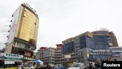 FILE - People walk through the streets of a shopping area in Addis Ababa, May 26, 2014. 