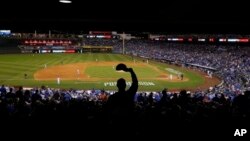 A Kansas City Royals fan cheers during the third inning of Game 3 of the American League baseball championship series.