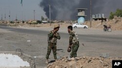 Iraqi security forces and Popular Mobilization Forces patrol in Tuz Khormato, which was evacuated by Kurdish security forces, 130 miles (210 kilometers) north of Baghdad, Iraq, Oct. 16, 2017. 