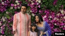 FILE - Actor Abhishek Bachchan, his wife actress Aishwarya Rai Bachchan and their daughter Aaradhya pose for a photo at a wedding at Bandra-Kurla Complex in Mumbai, India, March 9, 2019.