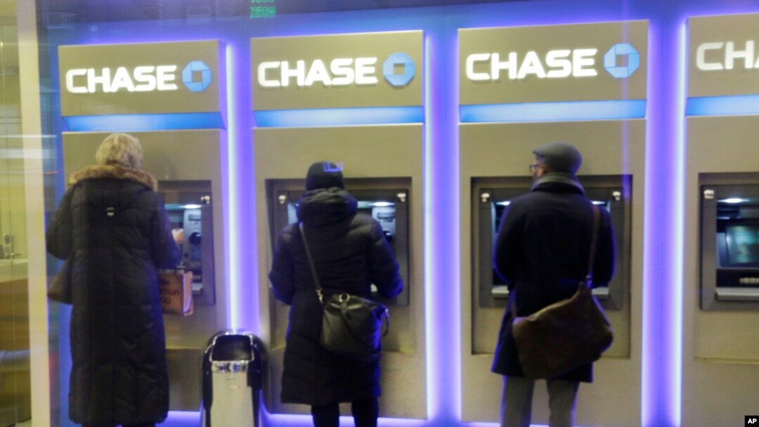 FILE - Customers uses ATM's at at a branch of Chase Bank.