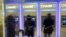 FILE - Customers uses ATM's at at a branch of Chase Bank.