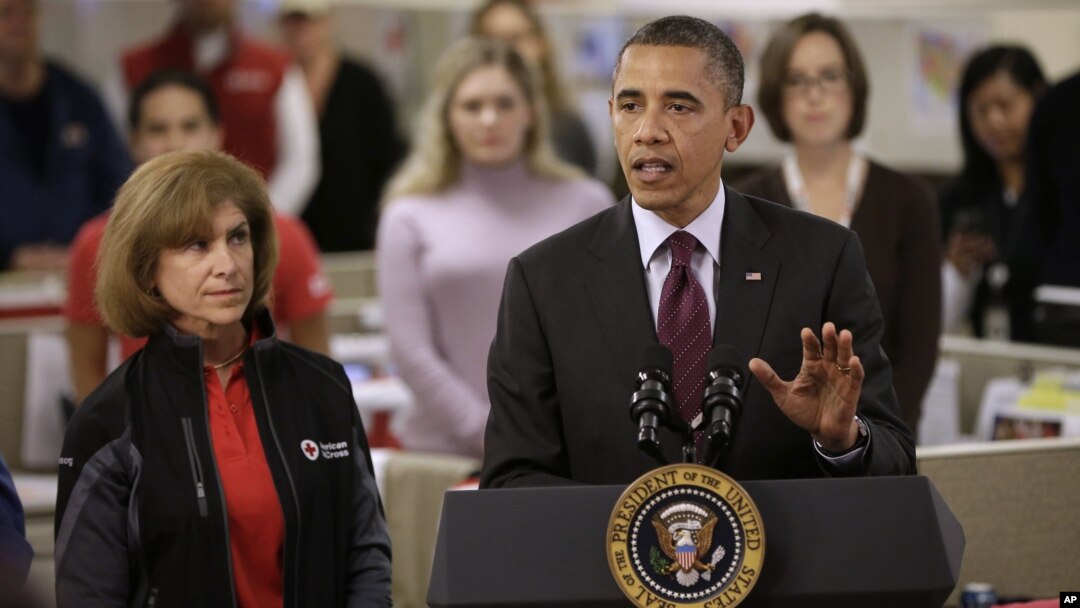 President Barack Obama, accompanied by American Red Cross President and CEO Gail J. McGovern, gestures while speaking during the his visit to the Disaster Operation Center of the Red Cross National Headquarter in Washington D.C. to discuss superstorm Sand