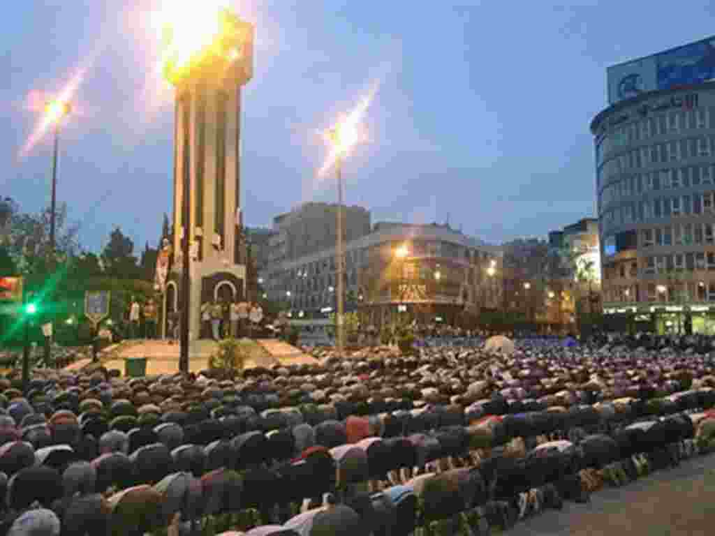 In this citizen journalism image acquired by The AP, Syrians pray in Clock Square in the center of the city of Homs, Syria, April 18 2011