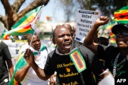 Members of the World Wide Forum for Economic Development gather to picket against sanctions imposed by the US on Zimbabwe at the US Embassy in Pretoria on October 25, 2023. (Phill MAGAKOE / AFP)