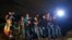 FILE - Immigrants from Honduras and El Salvador who crossed the Mexico-U.S. border illegally are stopped in Granjeno, Texas, June 25, 2014.