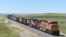 FILE - A BNSF Railway train hauling carloads of coal from the Powder River Basin of Montana and Wyoming is seen east of Hardin, Mont., on July 15, 2020. 