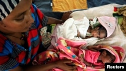 FILE - An Ethiopian woman who fled the ongoing fighting in Tigray region, nurses her newly born children inside a clinic in the Hamdayat camp on the Sudan-Ethiopia border, in eastern Kassala state, Sudan, Dec. 15, 2020.