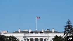 FILE - An American flag flies above the White House in Washington, Jan. 9, 2021. 