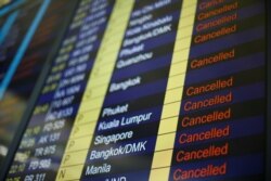 The departure board shows all flights leaving Hong Kong canceled, Aug. 12, 2019.