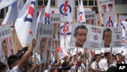 Supporters of the ruling People's Action Party (PAP), cheer their party leaders at a nomination center, Tuesday, Sept. 1, 2015.