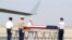 U.S. military guard of honor prepare to carry a coffin covered with U.S. national flag during repatriation ceremony at Mandalay International Airport, March 12, 2020, in Mandalay, central Myanmar.