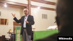 FILE - Ravi Zacharias speaks at Naval Station Guantanamo Bay, September 17, 2013.