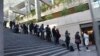 Media and members of the public line up outside the British Columbia Supreme Court to attend the trial of Meng Wanzhou, the chief financial officer of Huawei Technologies on Dec. 7, 2018 in Vancouver BC.