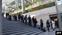 Media and members of the public line up outside the British Columbia Supreme Court to attend the trial of Meng Wanzhou, the chief financial officer of Huawei Technologies on Dec. 7, 2018 in Vancouver BC.