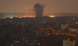 An explosion caused by Israeli airstrikes is seen in Gaza City, early Nov. 14, 2019. Israeli aircraft struck Islamic Jihad targets throughout the Gaza Strip on Wednesday while the militant group rained scores of rockets into Israel for a second day.