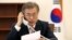 South Korean President Moon Jae-in speaks with Chinese President Xi Jinping by telephone at the Presidential Blue House in Seoul, South Korea, May 11, 2017.