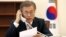 FILE - South Korean President Moon Jae-in speaks with Chinese President Xi Jinping by telephone at the Presidential Blue House in Seoul, South Korea, May 11, 2017.