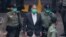 Hong Kong pro-democracy activist and media tycoon Jimmy Lai is escorted by Correctional Services officers to get on a prison van before appearing in a court, in Hong Kong, Saturday, Dec. 12, 2020. Lai, who founded the Apple Daily tabloid, has been…