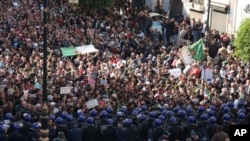 Algerian demonstrators take to the streets in the capital Algiers to protest against the government and reject the upcoming presidential elections, Dec. 11, 2019.