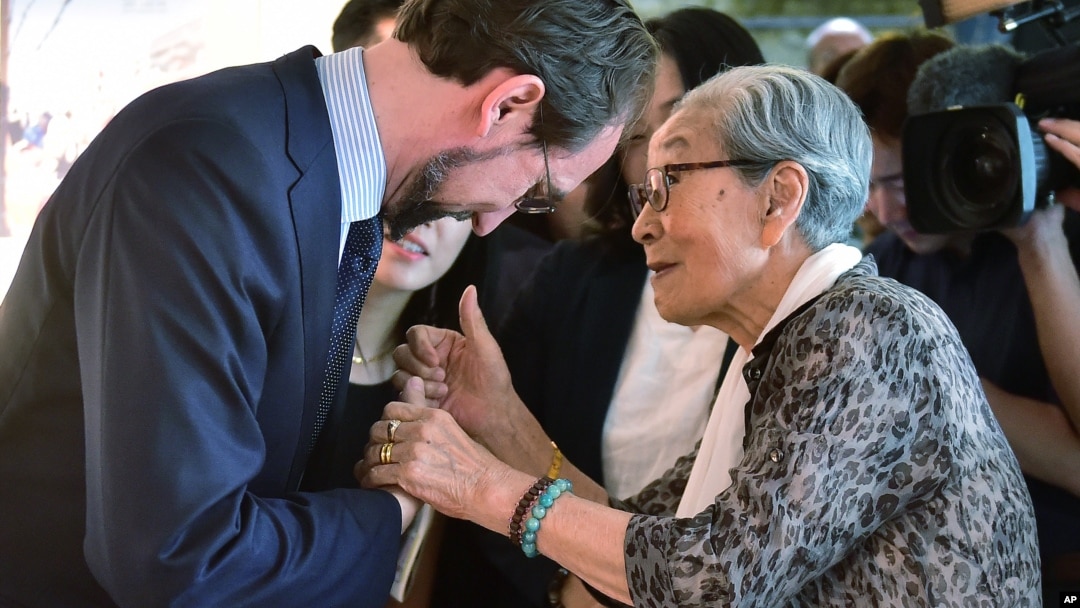 U.N. High Commissioner for Human Rights Zeid Ra'ad Al Hussein, left, is greeted by former South Korean comfort woman Kim Bock-dong, who was forced to serve for the Japanese troops as a sexual slave during World War II, as he visits the War and Women's Human Rights Museum in Seoul Wednesday, June 24, 2015. The United Nations opened a new office in Seoul on June 23 to monitor the human rights situation in North Korea. (Jung Yeon-je/Pool Photo via AP)