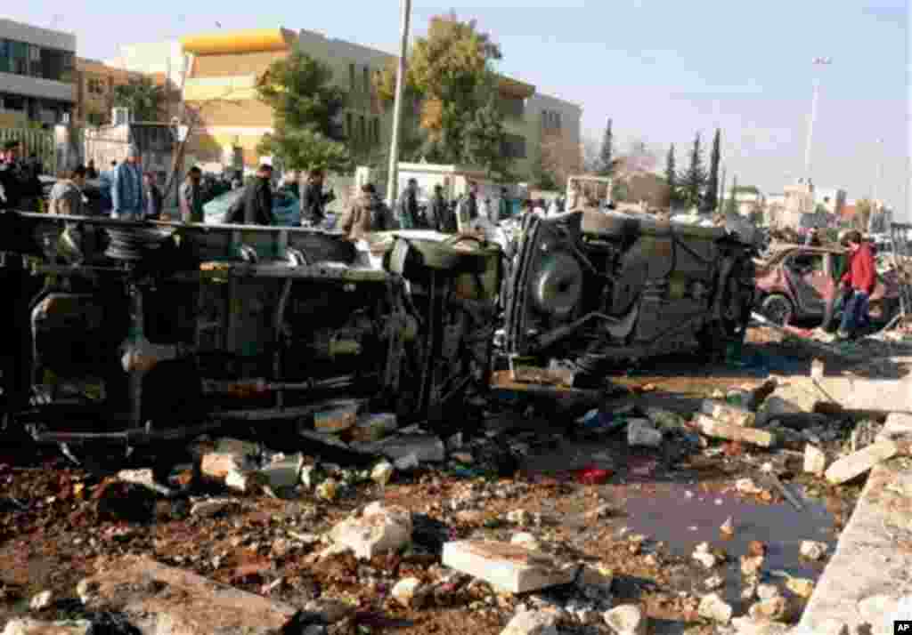 In this photo released by the Syrian official news agency SANA, Syrian people gather at the site after an explosion hit a university in Aleppo, Syria, Tuesday, Jan. 15, 2013. Two explosions struck the main university in the northern Syrian city of Aleppo 