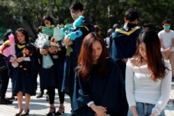 Graduates attend a ceremony to pay tribute to Chow Tsz-lok, 22, a university student who fell during protests earlier this week and died Friday morning, at the Hong Kong University of Science and Technology, in Hong Kong, Nov. 8, 2019.