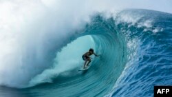 22 year-old Matahi Drollet surfs at Teahupoo off the coast of Tahiti in French Polynesia, May 11, 2020.