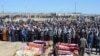 FILE - Iraqi mourners pray at the funeral of eight people killed a day earlier in attacks claimed by the Islamic State (IS) group, in the al-Bou Dor village of the Salaheddin governorate north of the capital, March 13, 2021.