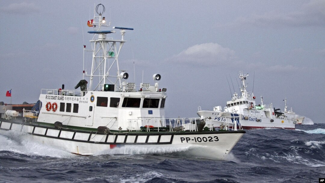 In this photo released by Taiwan's Central News Agency, a Taiwan Coast Guard patrol boat, front, comes in close proximity with a Japan Coast Guard patrol boat near the disputed islands called Senkaku in Japan and Diaoyu in China, in the East China Sea, Se