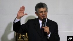 Parliamentary President Henry Ramos swears in newly elected members of the National Assembly in Caracas, Venezuela, Jan. 5, 2016.