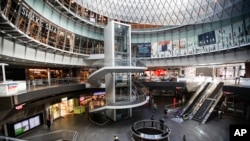 A pedestrian passes a nearly empty Fulton Center station as businesses are closed due to coronavirus concerns, Monday, March 16, 2020, in New York. 
