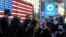 Coinbase employees gather outside the Nasdaq MarketSite during the company's IPO, in New York's Times Square, Wednesday, April 14, 2021. 