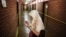 A Bosnian Muslim woman prays along a corridor with rooms where inmates were tortured, during the 20th anniversary of the closure of the Omarska detention camp in Omarska, Bosnia and Herzegovina, August 6, 2012.