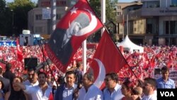 Demonstrators at Taksim Square wave flags bearing the face of Mustafa Kemal Ataturk, revered as founder of the modern Turkish Republic, July 24, 2016. Many are calling for preservation of the secular state established by Ataturk nearly a century ago. (L. Ramirez/VOA)