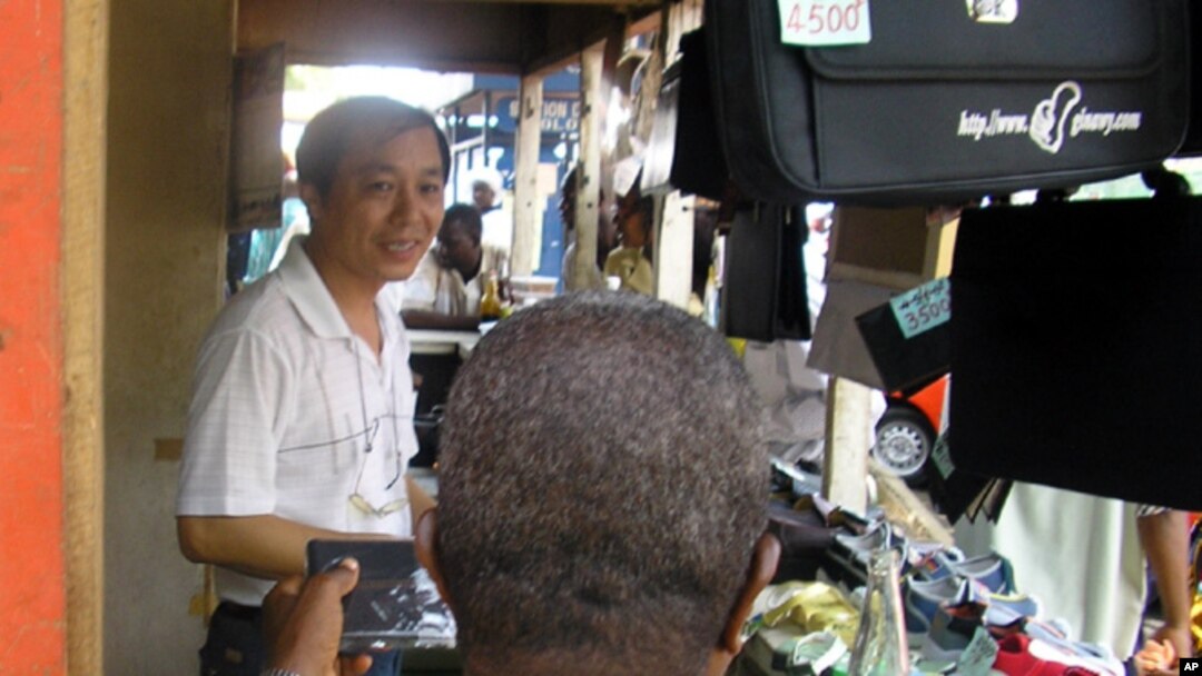 A Chinese salesman sells consumer goods in Abidjan, Ivory Coast