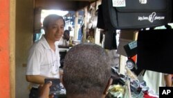 A Chinese salesman sells consumer goods in Abidjan, Ivory Coast