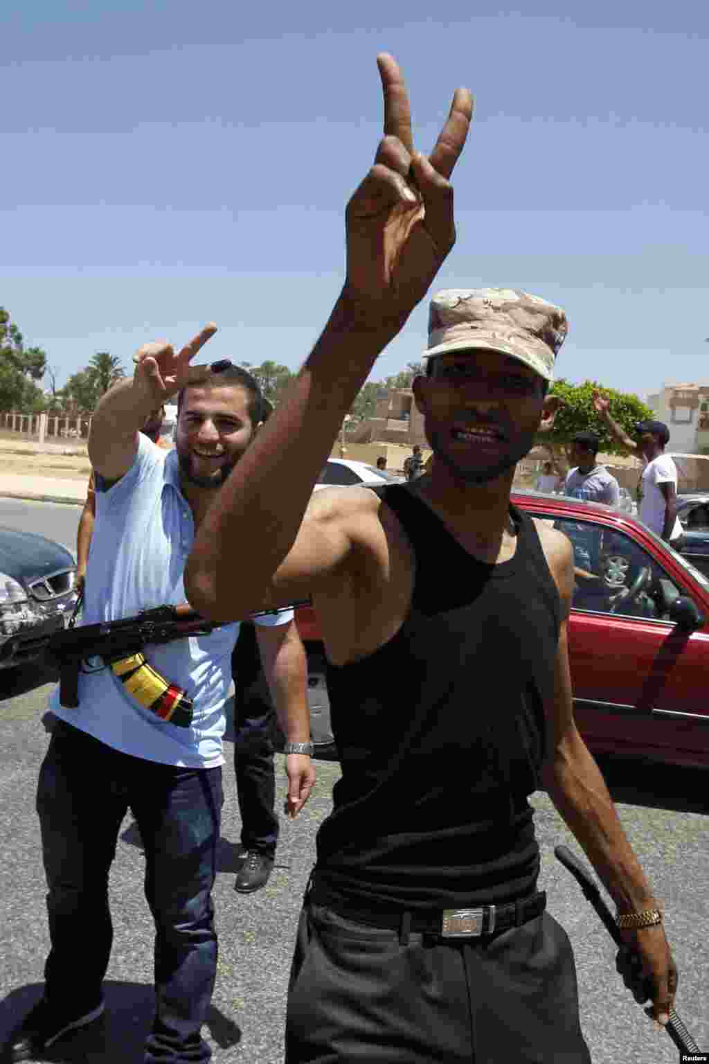 Libyans gather in the streets to celebrate the election, in Benghazi July 7, 2012. Crowds of joyful Libyans, some with tears in their eyes, parted with the legacy of Muammar Gaddafi on Saturday as they voted in the first free national election in 60 years