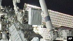 Flight Engineers Tracy Caldwell Dyson (l) and Doug Wheelock work to set up the ammonia spare pump module after it was installed on the S1 Truss, 16 Aug 2010