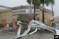 An apparent tornado caused by Hurricane Milton tore the awning off a 7-Eleven convenience store in Cape Coral, Florida, Oct. 9, 2024.