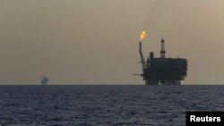 FILE - Offshore oil platforms are seen at the Bouri Oil Field off the coast of Libya, Aug. 3, 2015.