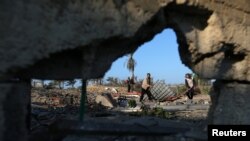 Palestinians inspect a site belonging to Hamas after it was targeted by Israeli warplanes in the southern Gaza Strip, Nov. 2, 2019.