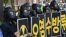 South Korean environmental activists wearing gas masks hold placards during a protest against Japan's decision to discharge Fukushima wastewater into the sea, near the Japanese Embassy in Seoul, June 4, 2021, a day before World Environment Day.