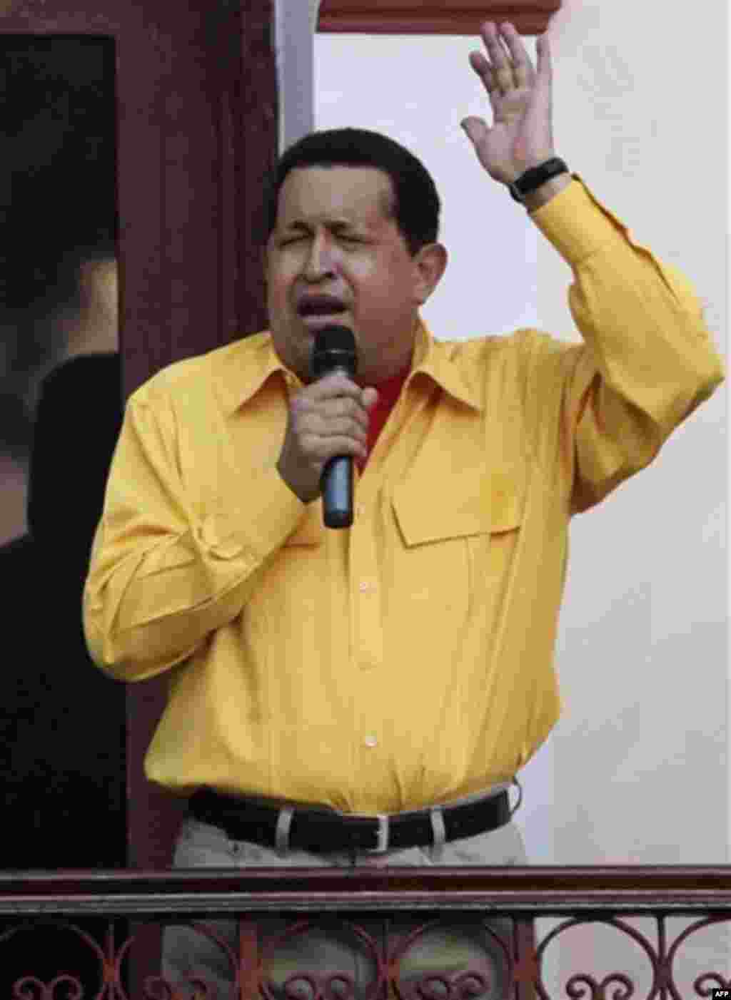 Venezuela's President Hugo Chavez sings on a balcony of Miraflores presidential palace in Caracas, Venezuela, Thursday, July 28, 2011. Chavez sang on a balcony of the presidential palace as he celebrated his 57th birthday before a crowd of supporters, vow